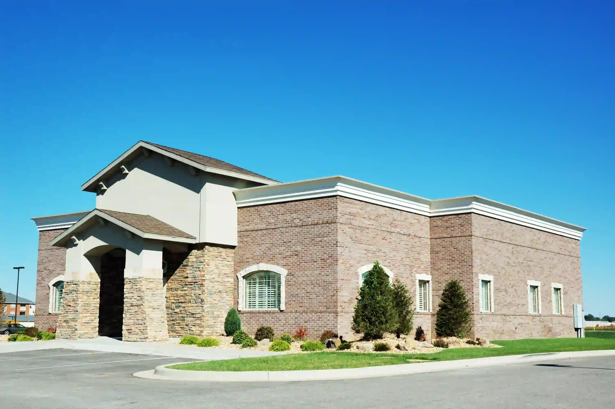Commercial masonry work including brick and stone facade installation on a commercial building